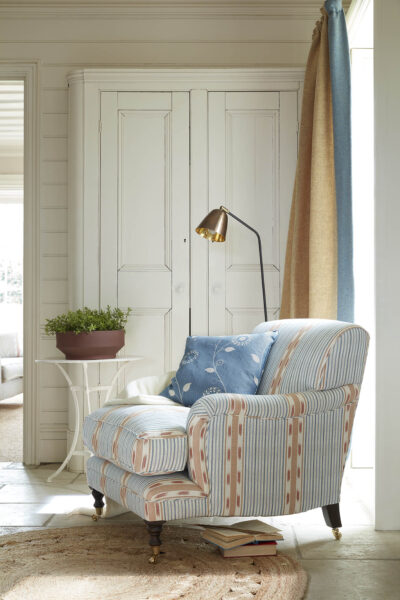 Upholstered armchair with lamp