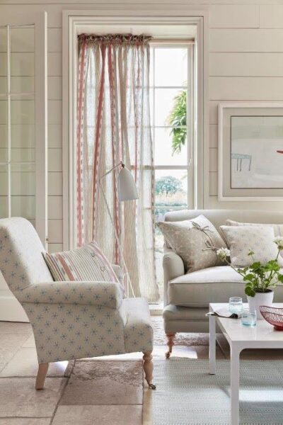 White sheer curtains and armchair