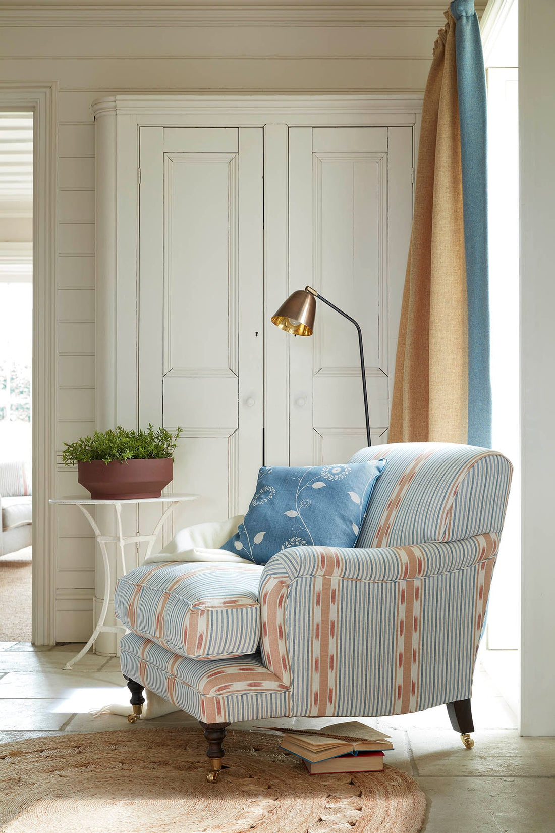 Upholstered armchair with lamp